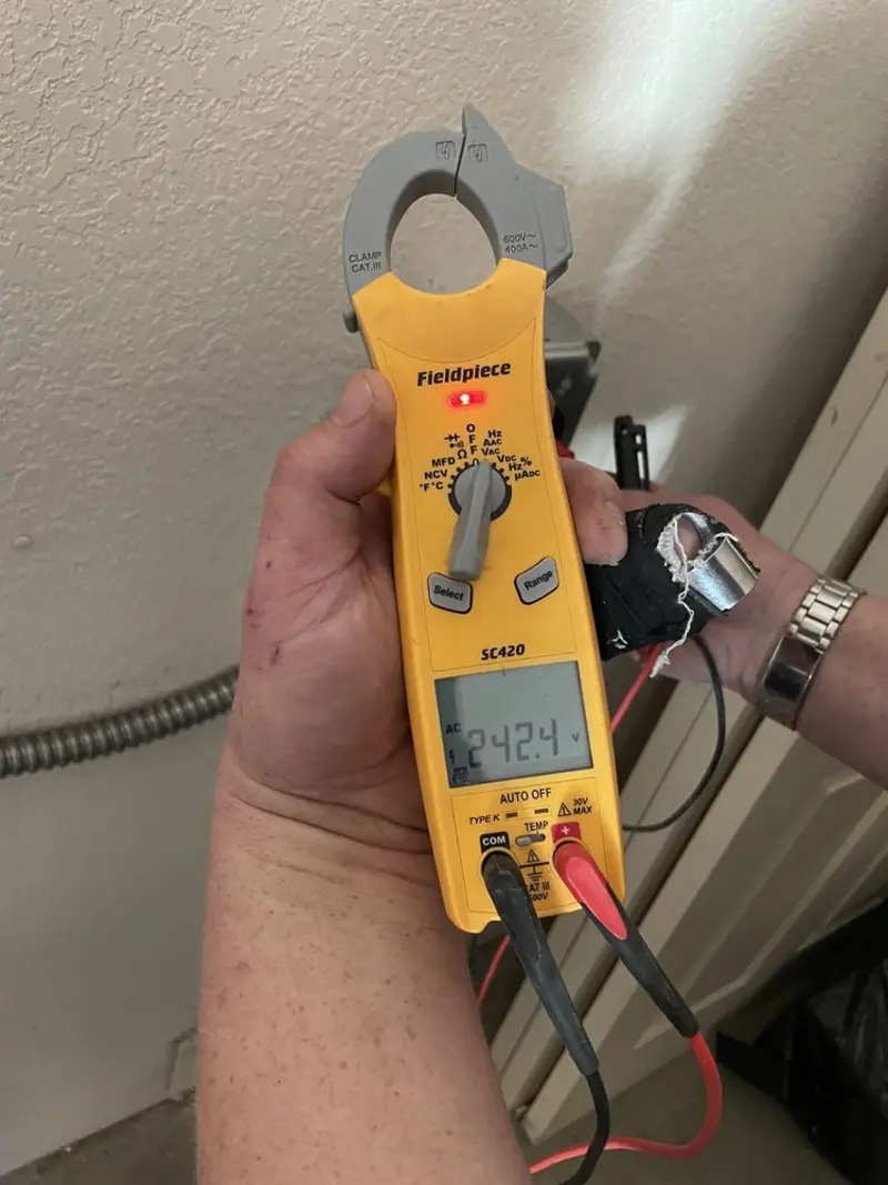 Voltage testing with clamp meter during Recessed Lighting Installation in Westlake
